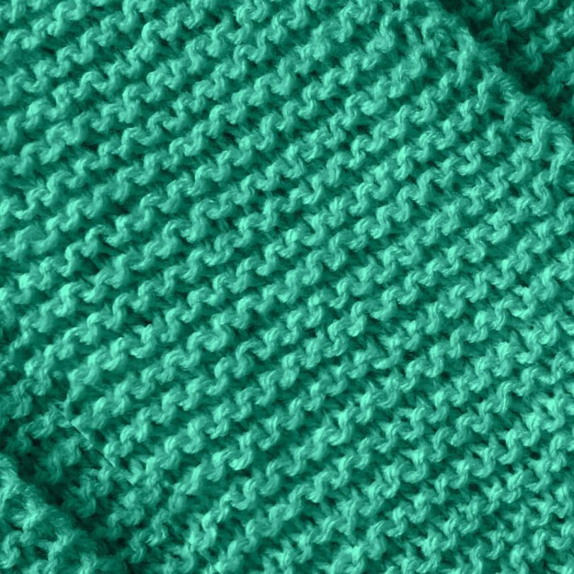 Detailaufnahme handgestrickter mintgrüner oversize Schal. Kjetil