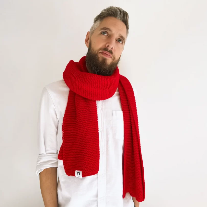 Modell mit handgestricktem rot farbenden oversize Schal. Rejk
